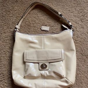 A genuine Coach hobo patent leather, ivory bag.